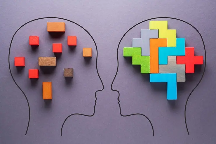 Two illustrated faces showing scattered and connected blocks, representing the importance of emotional intelligence in leadership and effective collaboration.